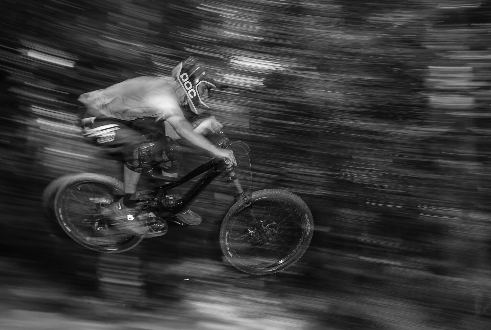 Mountain biker riding through a forest trail for MTB ride tracking